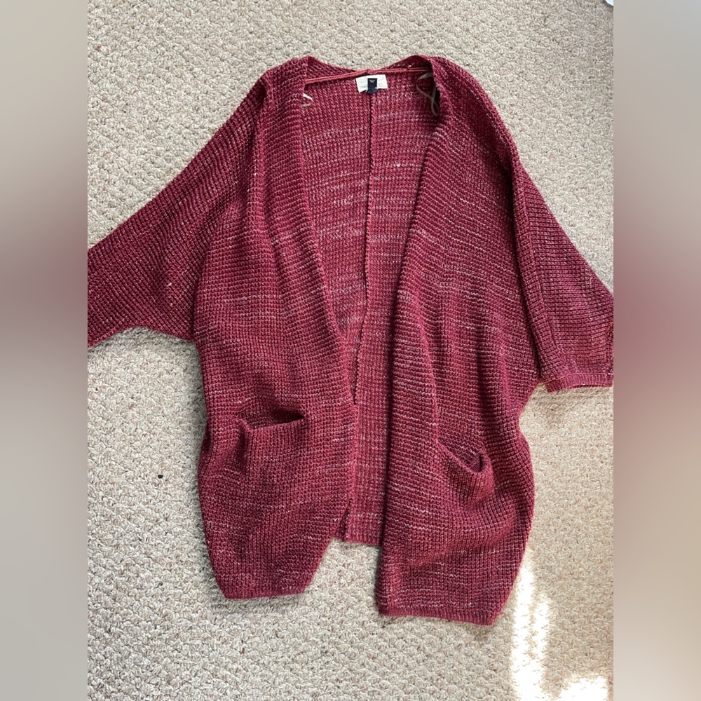 Red/maroon cardigan. No rips or tears. Has pockets.
